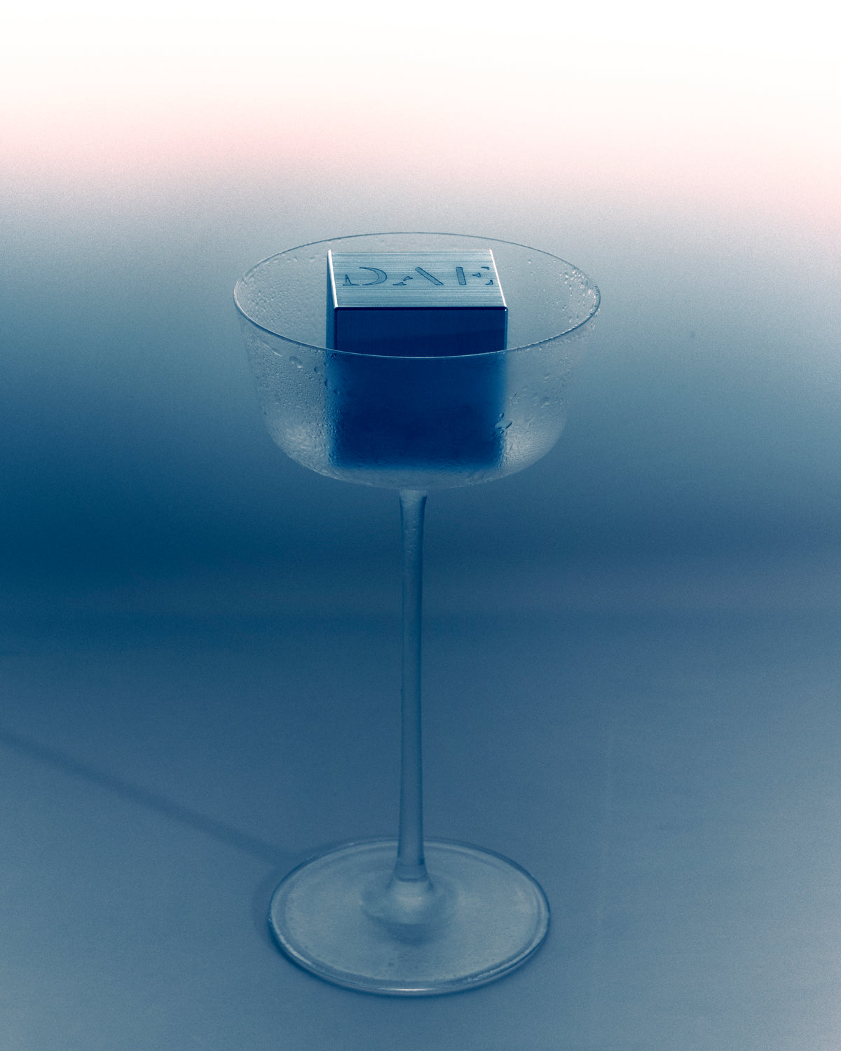 DAE New York campaign image - stemmed cocktail glass in blue tones